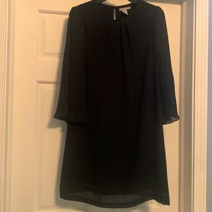 H&M lined black dress with unlined pleated sleeves.
